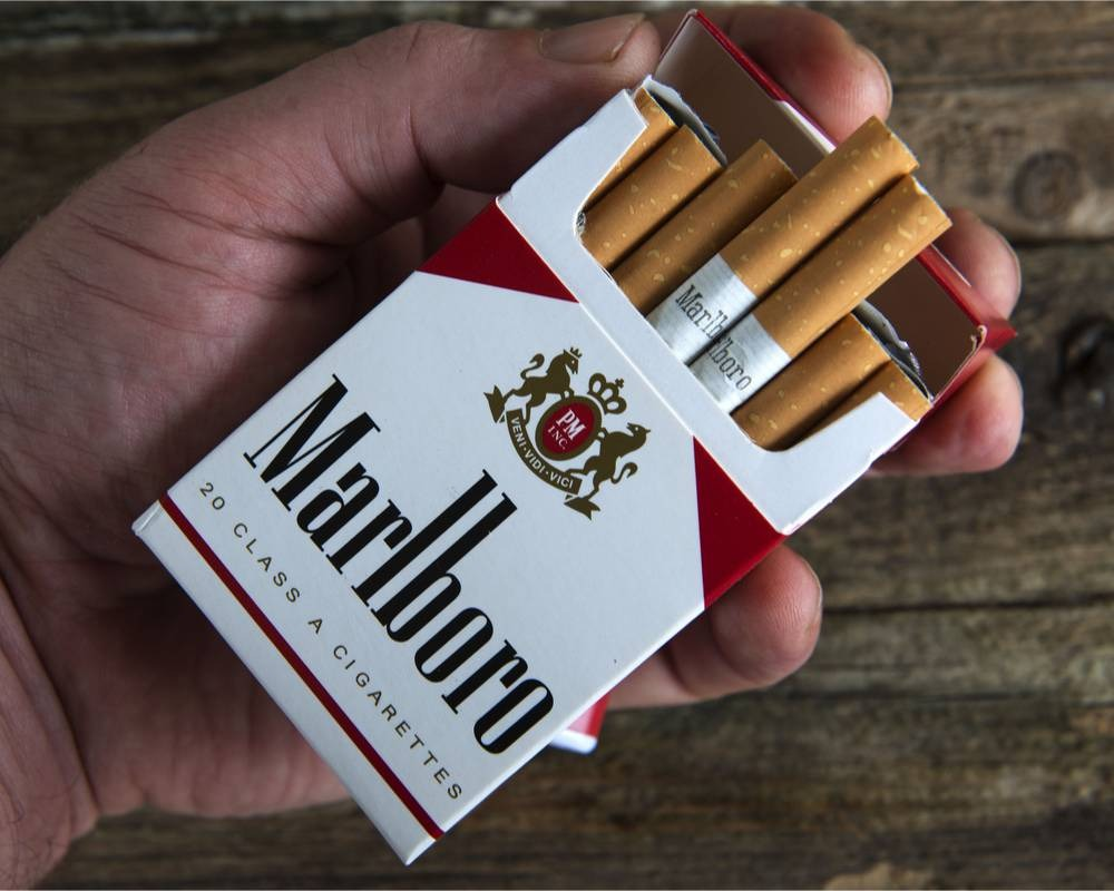 Open cigarette pack shown in hand
